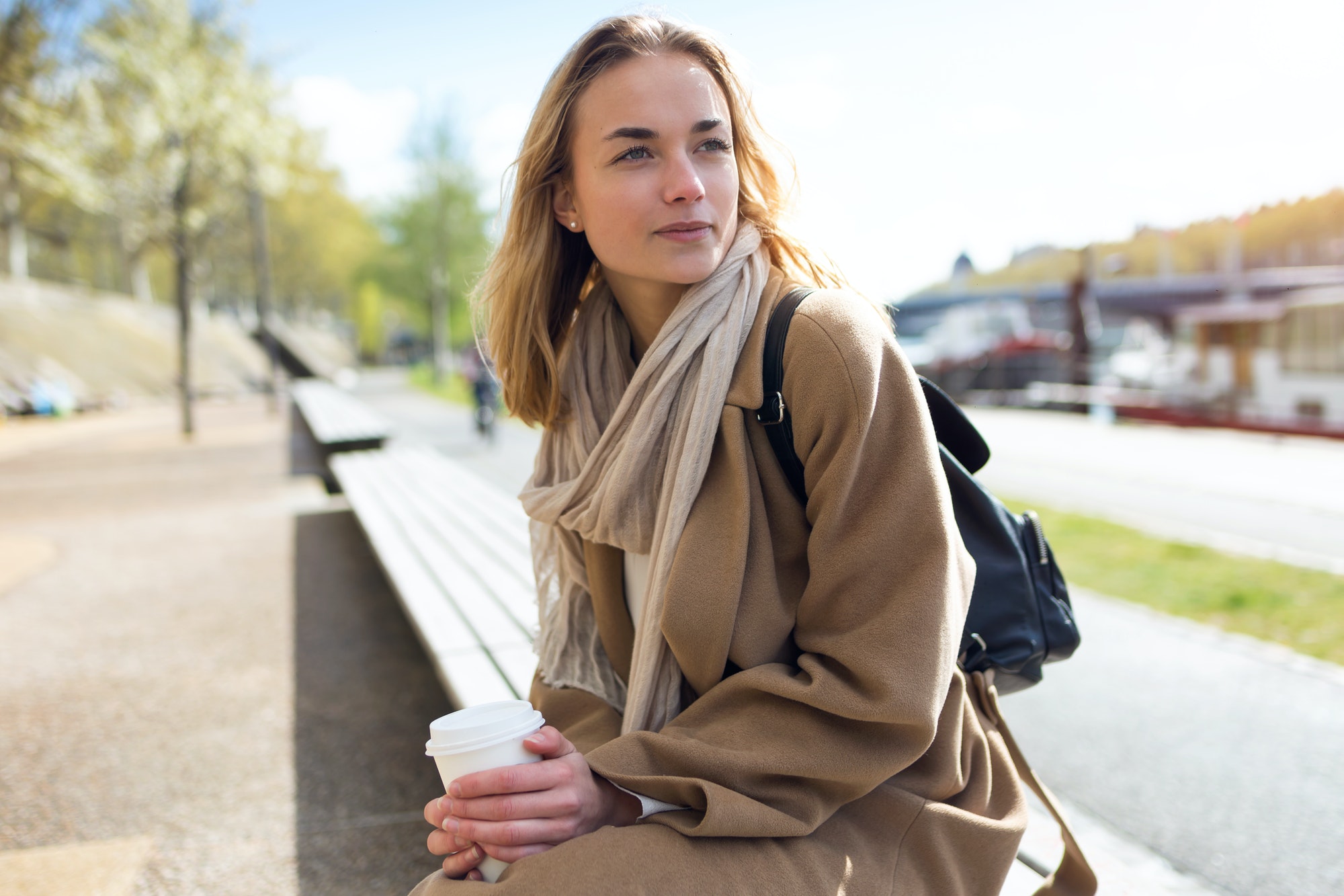 Pretty young woman thinking and looking to sideways in the park.
