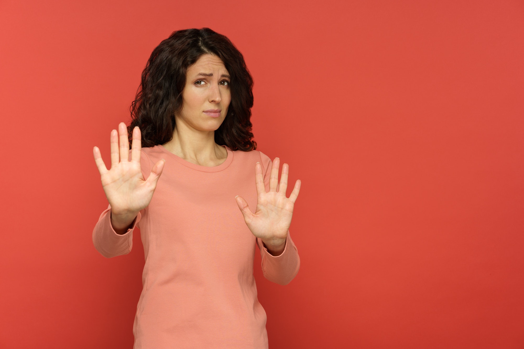 woman making a "no" gesture out of disgust