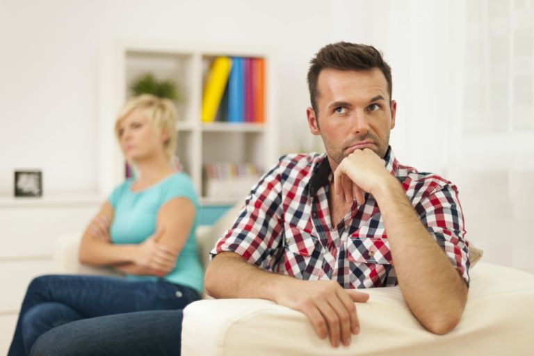 how to deal with taking a break in a relationship concept, couple sitting on couch