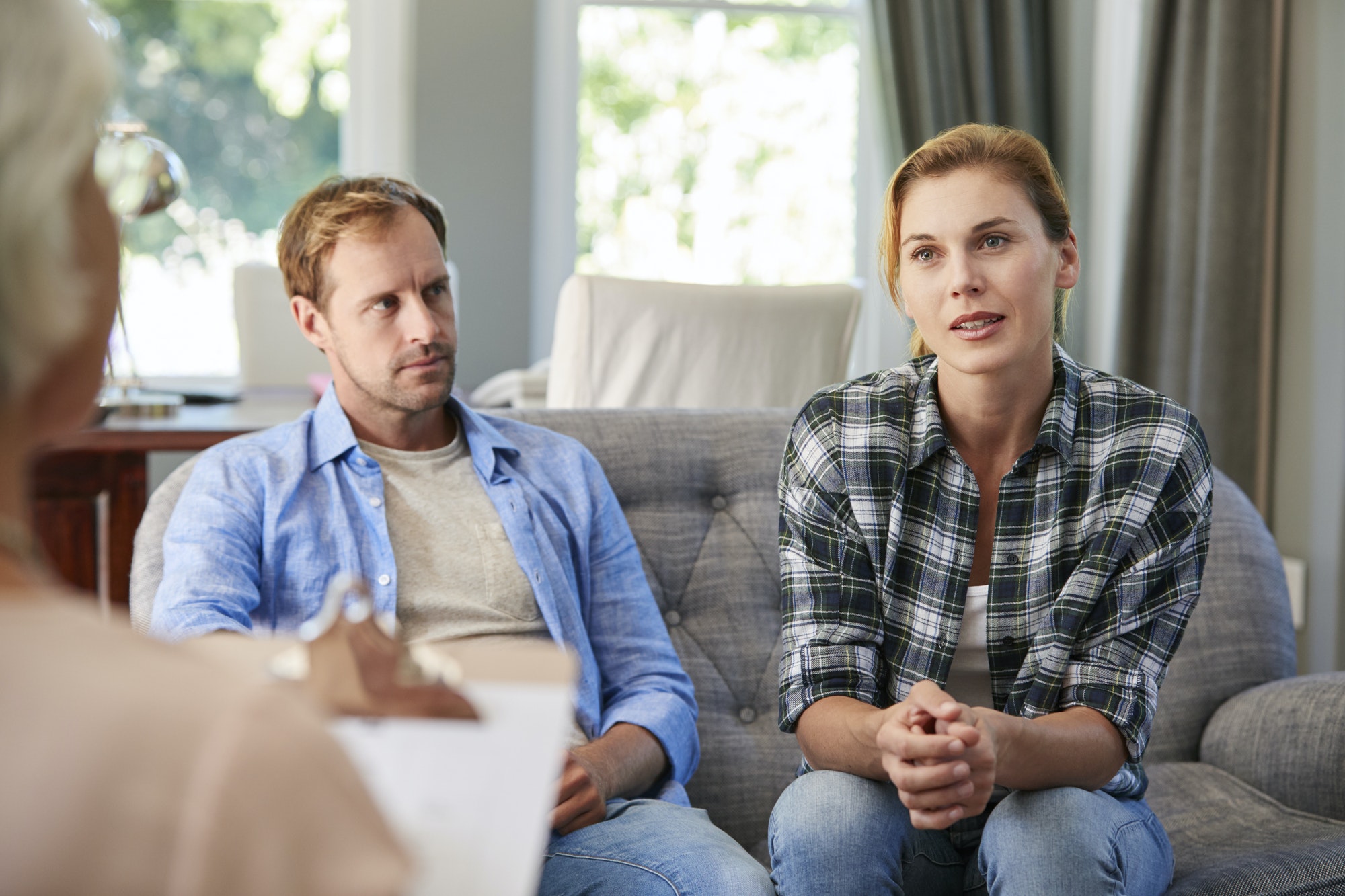 Young couple talking to heir a marriage counselor