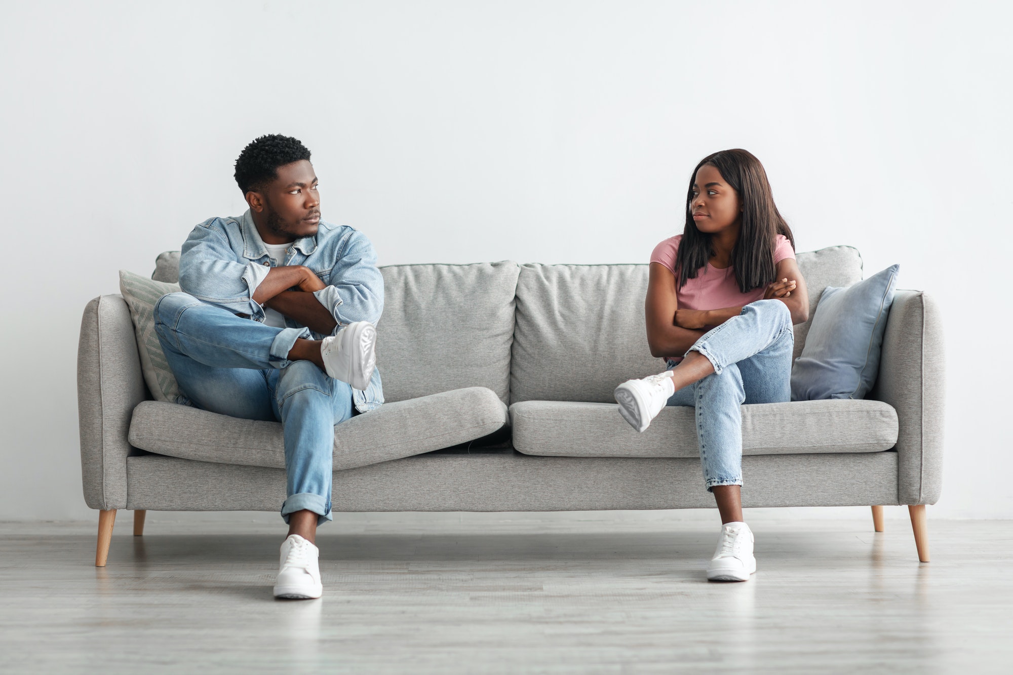 Young married black couple having fight, ignoring each other because of infidelity